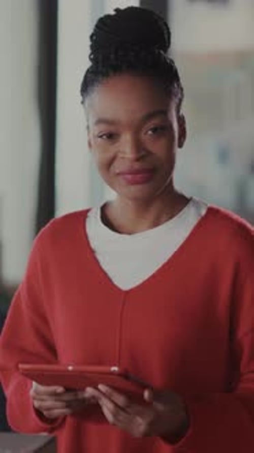 Businesswoman Managing Orders Confidently Smiling Woman in Studio Verifies Shipping Labels at Her