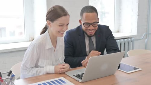 Smiling Professionals Video Call in Bright Office
