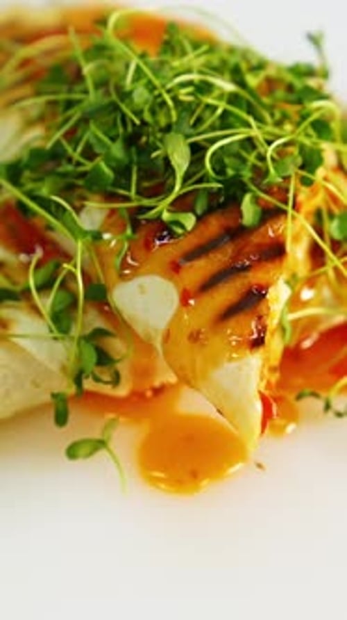 Fry pita bread on white plate. Shawarma fried on grill with microgreen on top.