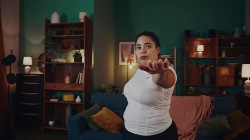 African American Woman Practices Warrior Asana at Home