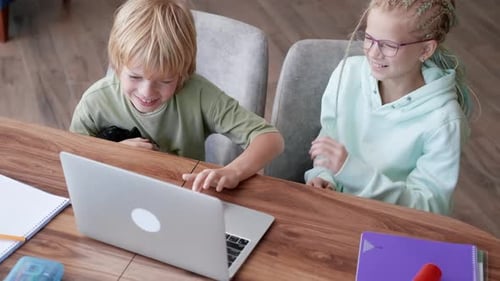 Online School Class Siblings Pupils Boy and Girl Learning Together Remotely Online at Home Looking