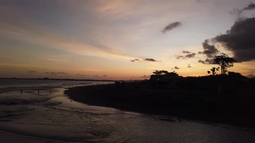 Island Silhouette at Sunset Black Sand Beach in Bali, Gianyar Indonesia, Ketewel Golden Hour Horizon