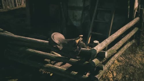 Vintage Saddle Resting on a Wooden Fence in a Rural Setting