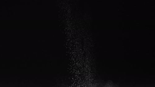 White Powder Exploding Against Black Background