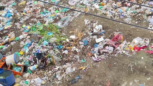 Environmental pollution: Plastic waste and city garbage polluted soil.