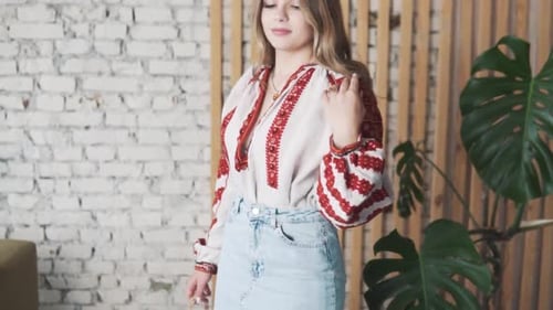 Woman Smiling and Modeling in Embroidered Blouse