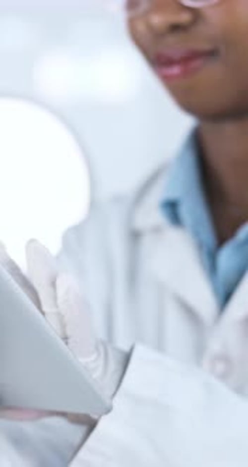 Medical Researcher Works on Tablet in Laboratory