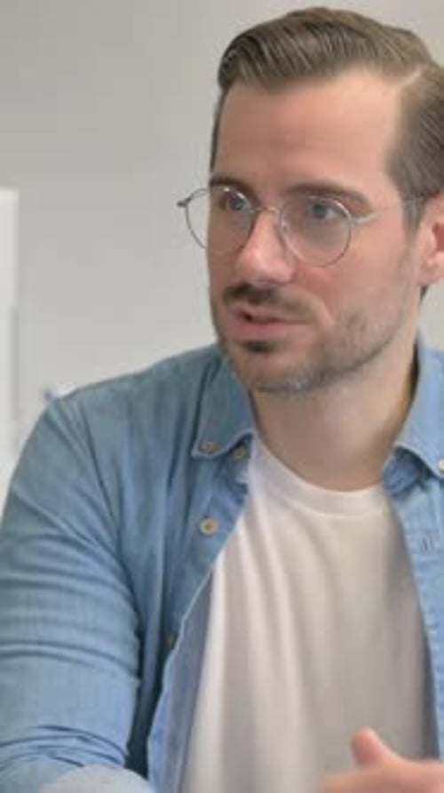 Close up of Young Man Talking with Teammate in Office, vertical video