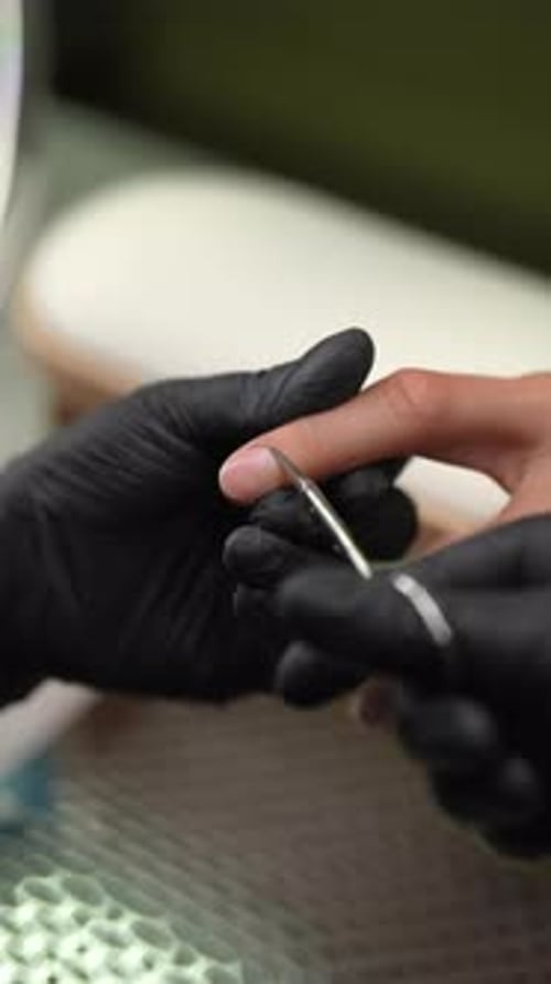 Professional Manicurist Skillfully Trimming Man Cuticles Showcasing Meticulous Grooming at Beauty