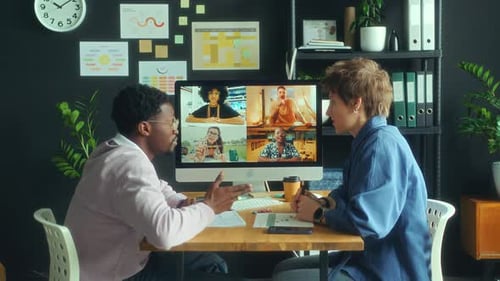 Colleagues Web Conferencing with Business Team in Office
