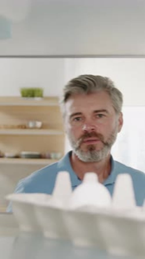 Man Taking an Egg Out of Refrigerator