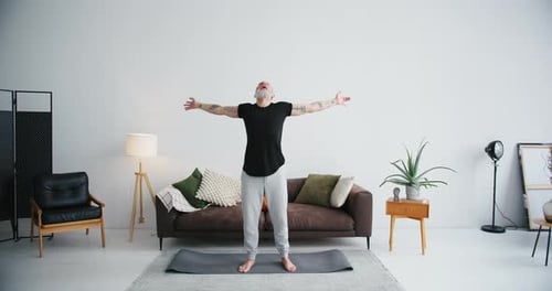 Adult Performs Yoga and Stretches at Home