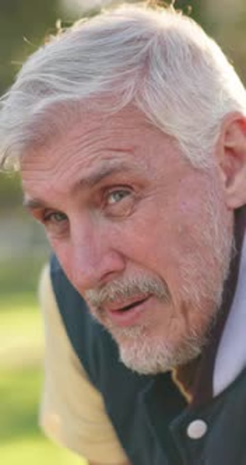 Smiling Senior Man Wearing Jacket outside in the Daytime