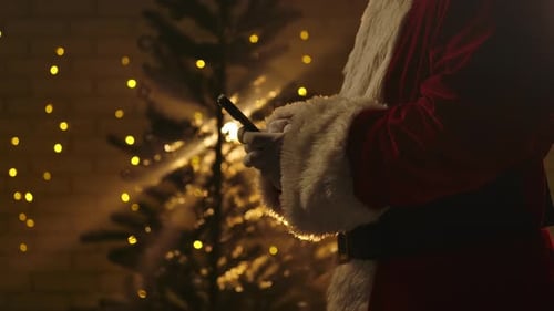 Santa Claus Using Mobile Phone in Festive Setting