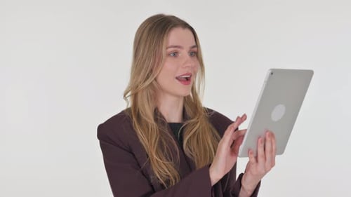 Woman Video Chats on Tablet Smiling and Celebrating