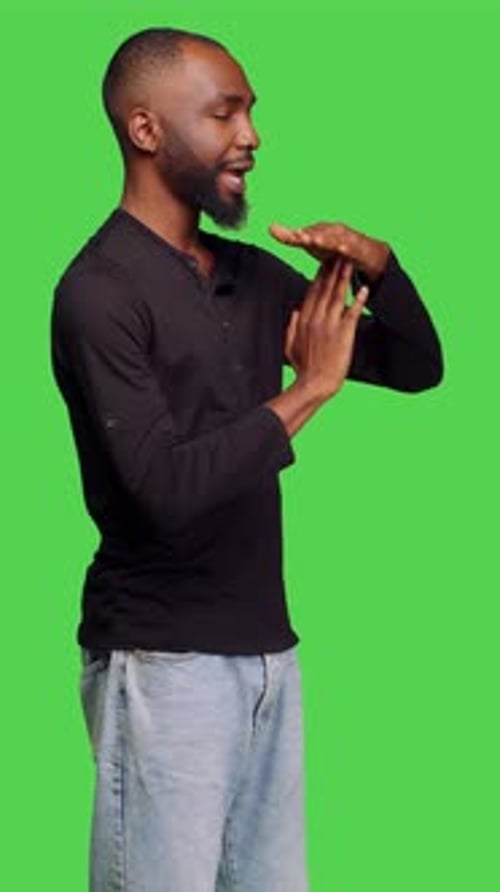 Vertical Video Side View of Confident Casual Man Expressing Timeout Gesture in Studio