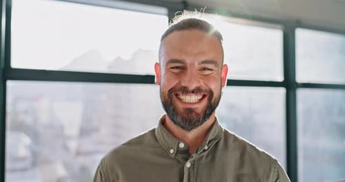 Man Smiles in Bright Modern Office Setting