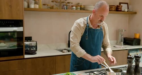 Man Cooking Food in Home Kitchen