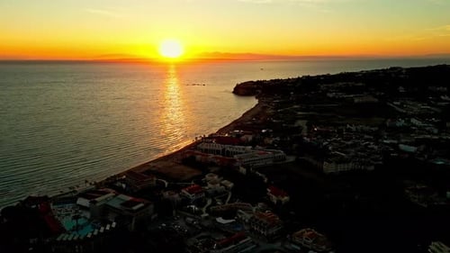 Luxury Beachfront Hotel And Resort At Sunset On Crete Island, Greece. Aerial Wide Shot