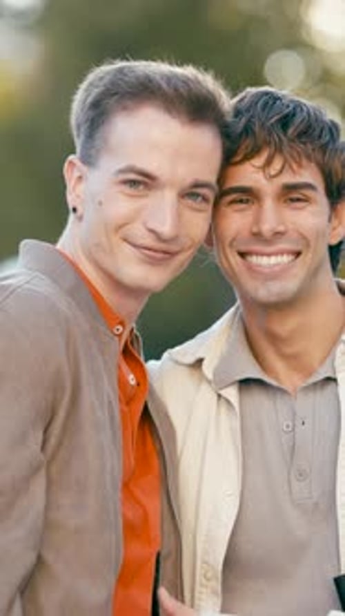 Smiling Men Embracing Outdoors in Natural Light