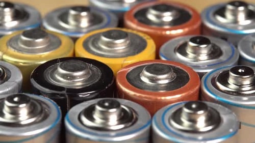 Rows of used alkaline AA batteries. Lithium ion battery pack close up. Electric power supply