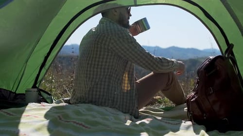 Hiker Tourist Traveler Man Drinking Hot Thermos Cup Mountain Camping Camp Tent Traveling Hikingю