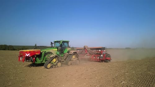 Tractor on the field seeding wheat