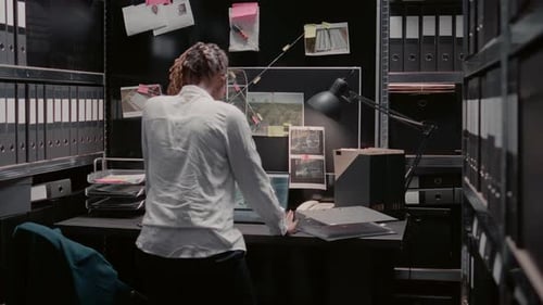 Law Agency Detective Reading Criminal Records in Archive