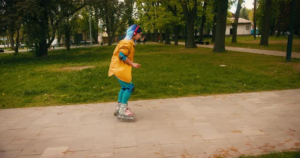 Teenager Roller Skater Girl with Blue Hair Riding Practicing Stunt ...