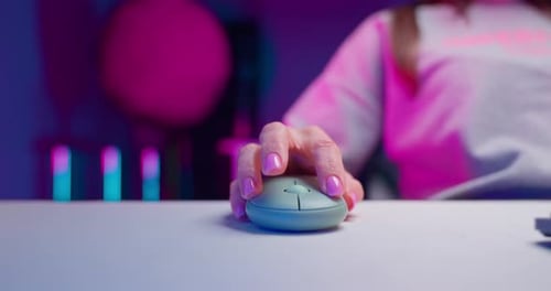 Hand Using Computer Mouse with Colorful Lighting