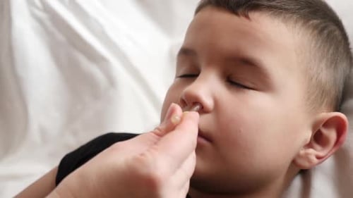 Child Receiving Nasal Drops in Close Up Shot