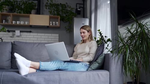 Woman Video Calling at Home on Laptop