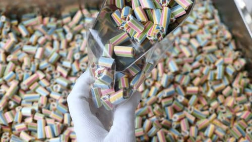 Closeup of a Lot of Sliced Lollipops The Cook Pours Sweets Into Bags Packing