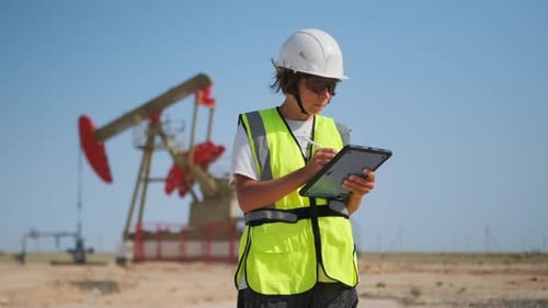 Woman Engineer Making Digital Notes at Oil Pump Site