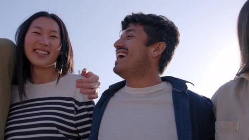 Friends laughing together at the beach