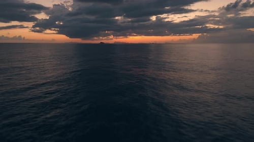 Quick Flight Towards Sunset Over Endless Ocean Blazing Sunset Merges with Water Surface Creating