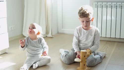 Children Playing with Toys on the Floor
