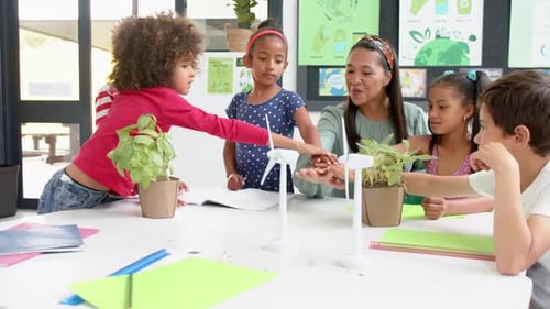 In school, teacher and students discussing plants and renewable energy projects