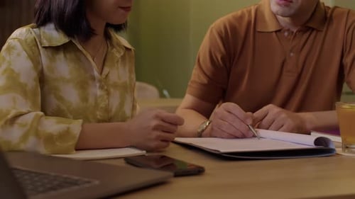 Business Meeting With Man and Woman Signing Document