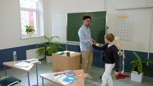 Elementary School Class Children Communicate with the Teacher Answering Question