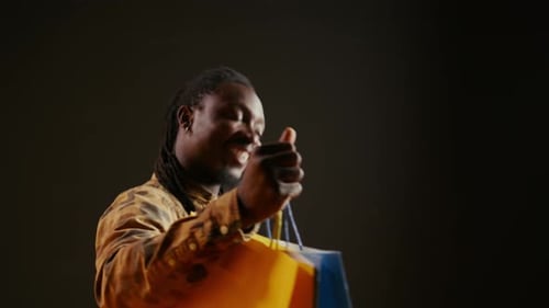 Happy Young Adult with Shopping Bags Smiling
