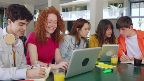 Young Students Group Working Together with Laptop Computers at College Library