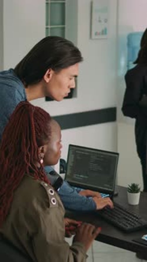 Tech Team Collaborates on Software in Modern Office