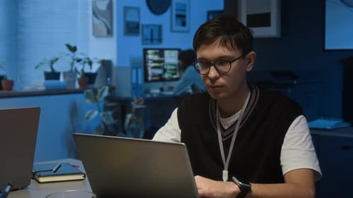 Portrait of Male Project Wearing Vest with T-shirt during Workday in Dark Office