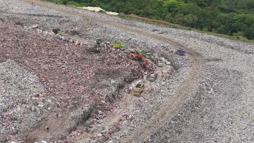 Aerial view of garbage trucks at a large landfill