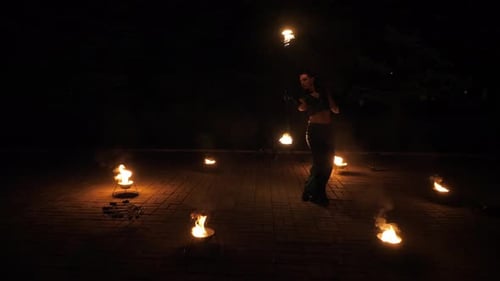 Woman Performing Fire Dance at Night in City