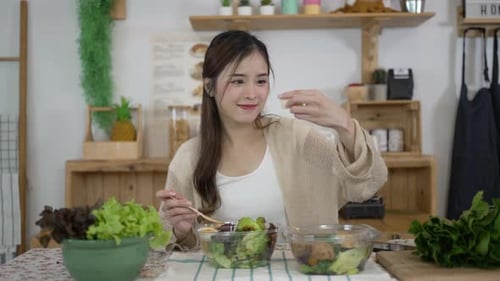 Woman Makes a Fresh Salad in Kitchen
