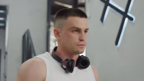 Fitness Enthusiast Walking Toward Gym Equipment Station