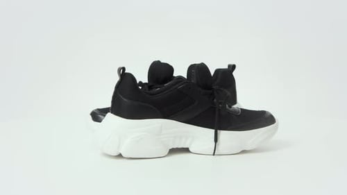Pair of Black and White Athletic Fashion Shoes