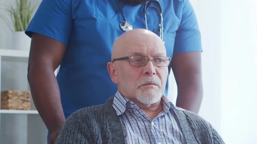 AfricanAmerican Caregiver and Old Man Professional Nurse and Patient in a Nursing Home Assistance